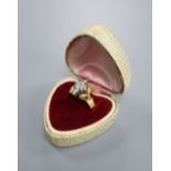 An 18ct and diamond cluster dress ring, in a raised setting, size Q/R, gross 5.9 grams.CONDITION: