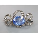 An early 20th century white metal, fancy cut sapphire and diamond chip set scroll pendant brooch,