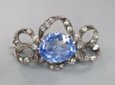 An early 20th century white metal, fancy cut sapphire and diamond chip set scroll pendant brooch,