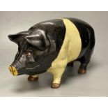 A large heavy cast iron saddle back pig money bank, circa 1950's, length 46cmCONDITION: Structurally