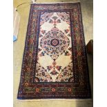 A North West Persian cream ground rug, 133 x 76cmCONDITION: Good condition with no faults noted.