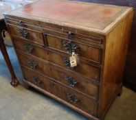 A George I walnut chest, with brushing slide, two short and three graduated long drawers, width