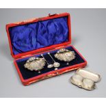 A pair of Edwardian silver shell salts and spoons and a similar twin compartment sovereign case,