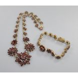 A 19th century gilt white metal and facet cut garnet set bracelet and similar necklace, 40cm.