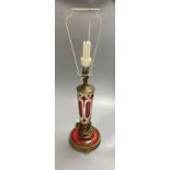 A 19th century Bohemian overlay ruby glass lamp, on engraved brass plinth, 34cm excluding light