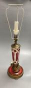 A 19th century Bohemian overlay ruby glass lamp, on engraved brass plinth, 34cm excluding light