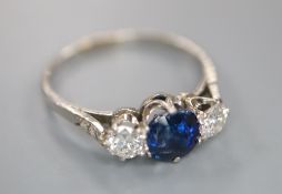 A white metal, sapphire and diamond three stone ring, with diamond chip set shoulders, size Q, gross