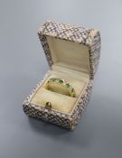 A mid to late 20th century yellow metal, emerald and diamond set full eternity ring, size P/Q, gross