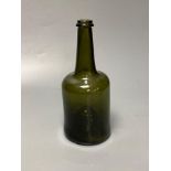 An early 18th century dark green glass wine bottle with a "kick in" based, 23cmCONDITION: Good