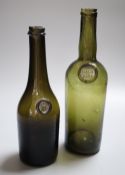 Two 19th century French green glass wine and spirit bottles, one with an armorial seal, the other