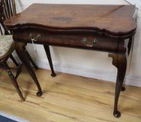 A George I red walnut serpentine top card table, with dished corners, frieze drawer and slender