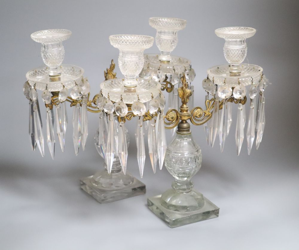 A pair of cut glass and ormolu two branch lustres, on square basesCONDITION: One lustre is