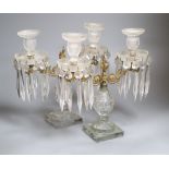 A pair of cut glass and ormolu two branch lustres, on square basesCONDITION: One lustre is