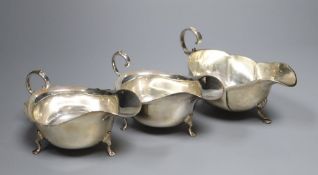 A pair of George V silver sauceboats, Barker Brothers, Chester, 1925 and one other earlier