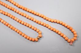 A single strand coral bead necklace, with yellow metal spacer, 197cm, gross weight 56 grams,