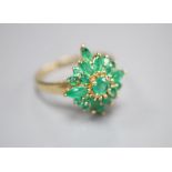A modern 9ct gold and emerald cluster ring, size R, gross 3.4 grams.CONDITION: One of the larger