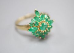 A modern 9ct gold and emerald cluster ring, size R, gross 3.4 grams.CONDITION: One of the larger