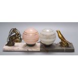 Two French Art Deco style table lamps, with animal surmounts, marble plinths and globular glass