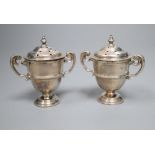 A cased pair of late Victorian small silver trophy shaped pepper pots, Horace Woodward & Co, London,