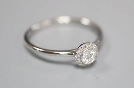 A modern 18ct white gold and diamond cluster ring, size O, gross 1.6 grams.CONDITION: Central