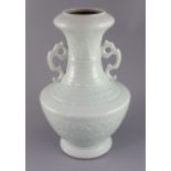 A Chinese celadon glazed two handled vase, finely decorated with peonies and scrolling foliage,