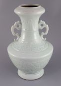 A Chinese celadon glazed two handled vase, finely decorated with peonies and scrolling foliage,