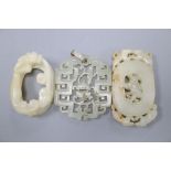 Two Chinese white jade carvings, 6.5cm and 5cm, and a Chinese pale celadon jade pendant, 5.