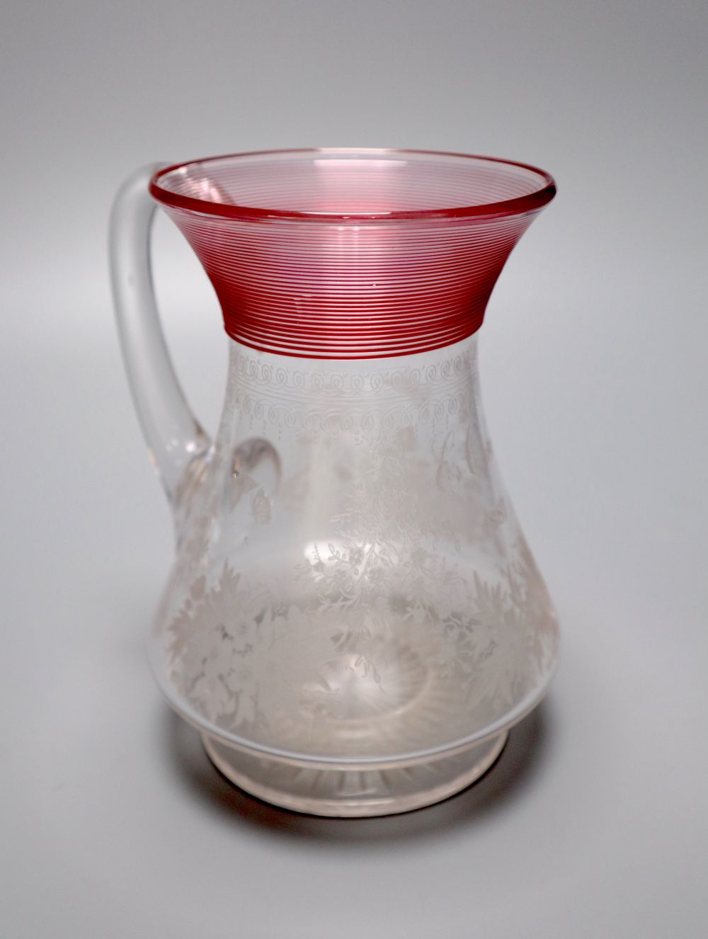 A Victorian 'E. Oakes 1887' etched commemorative jug, with red trailing to the neck, 16.5cm