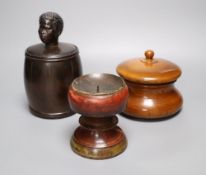 A 19th century ash jar and cover, a beech tobacco jar and a painted beech pricket candlestick, 11.