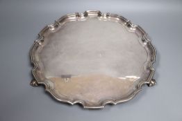 A modern silver salver, with a piecrust border, on three scroll feet, Wakely & Wheeler, London,