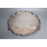 A modern silver salver, with a piecrust border, on three scroll feet, Wakely & Wheeler, London,