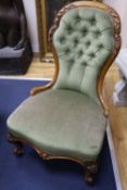 A Victorian carved walnut nursing chair