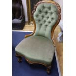 A Victorian carved walnut nursing chair