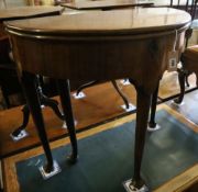 A George II mahogany and fruitwood games table, with hinged top and raised on pole and pad supports,