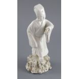 A Chinese blanc de chine figure of an official holding a scroll, Qing dynasty, on a rockwork base,