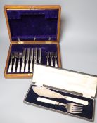 A cased pair of plated bone handled fish servers and a set of five (ex 6) mother o'pearl handled