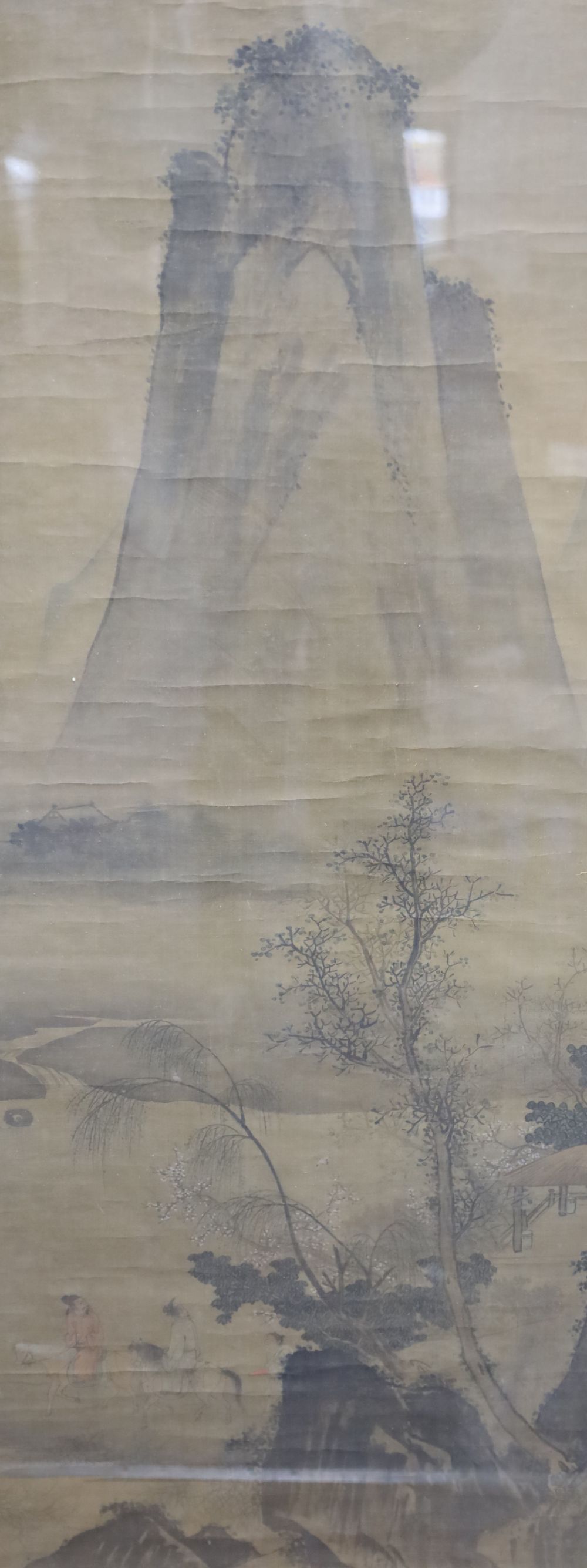 A Chinese watercolour on silk, Travellers passing a mountain peak, 120 x 48cmCONDITION: