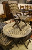 A circular teak garden folding table and four chairs, table diameter 118cm