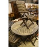 A circular teak garden folding table and four chairs, table diameter 118cm