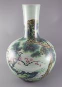 A large Chinese celadon ground famille rose 'prunus and pine' bottle vase, Qianlong mark to the