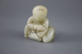 A Chinese pale celadon jade group of a seated boy and a duck, the stone with some occasional