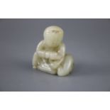 A Chinese pale celadon jade group of a seated boy and a duck, the stone with some occasional