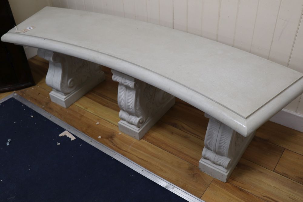 A reconstituted marble concave garden bench, width 150cm height 46cmCONDITION: Top looks to have