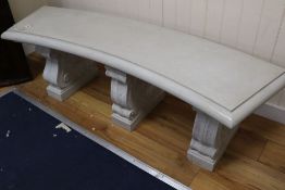 A reconstituted marble concave garden bench, width 150cm height 46cmCONDITION: Top looks to have
