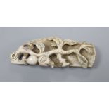 A cream-coloured soapstone carving, floral sprig, 10cm