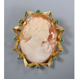 A Victorian style yellow metal and green stone mounted oval cameo shell brooch, carved with the bust
