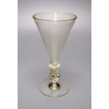 A façon de Venise historismus wine glass, 20th century, the conical bowl above a 'propeller' stem,