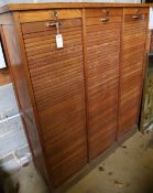 An oak triple tambour filing cabinet, width 128cm depth 39cm height 148cm