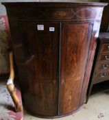 A George III inlaid mahogany bowfronted hanging corner cupboard, width 74cm depth 48cm height 110cm