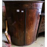 A George III inlaid mahogany bowfronted hanging corner cupboard, width 74cm depth 48cm height 110cm